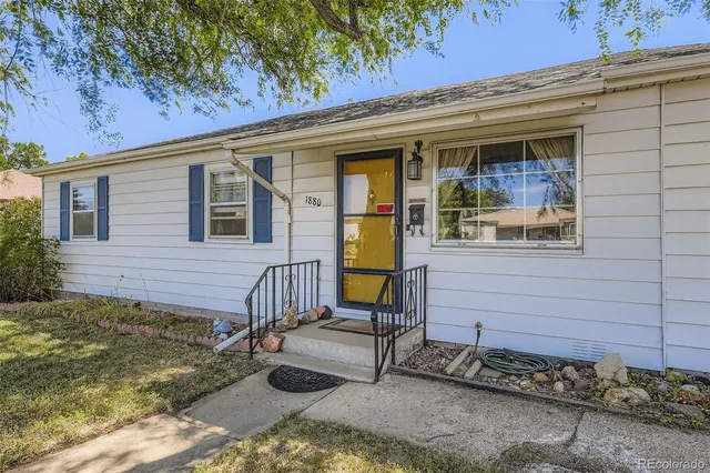 a view of a house with a chairs in patio