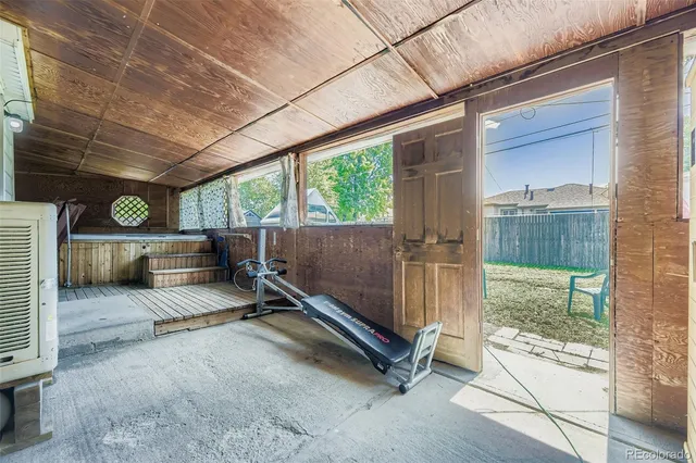 a view of backyard with wooden floor and outdoor seating