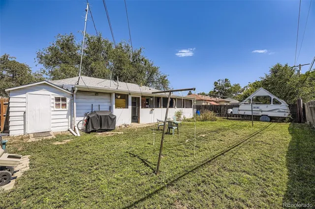 a view of a house with pool and chairs