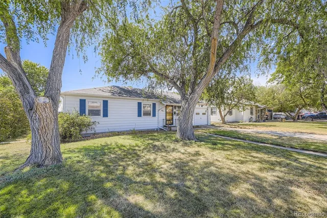 a view of a house with a tree in the yard