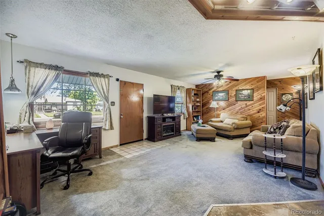 a view of a livingroom with furniture and a window