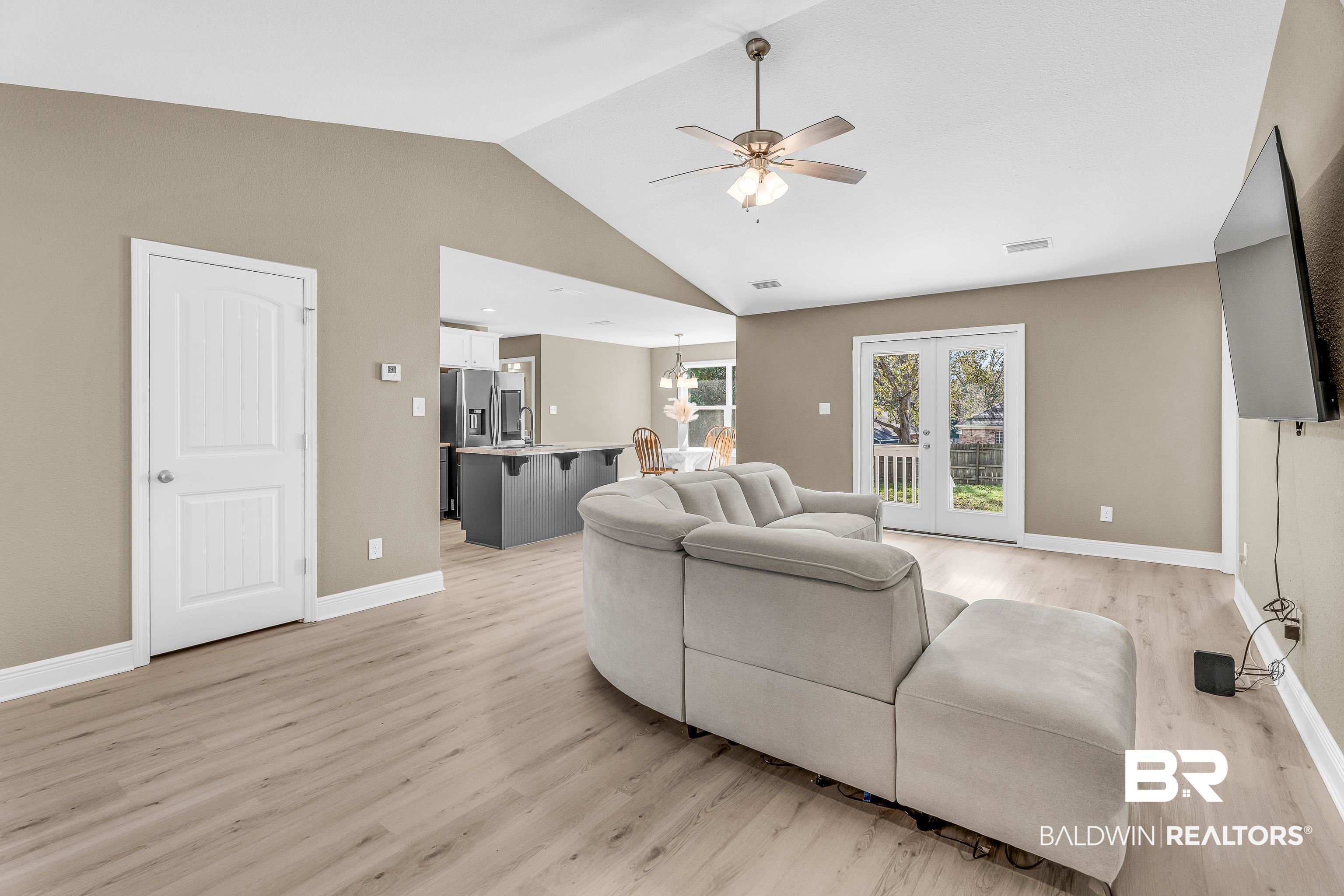 9206 Greenleaf Drive Daphne, AL 36527 - Photo 6 of 32 Living room with lofted ceiling, a ceiling fan, light wood-type flooring, and french doors