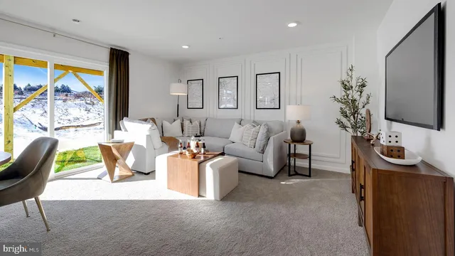 a living room with furniture a chandelier and a flat screen tv