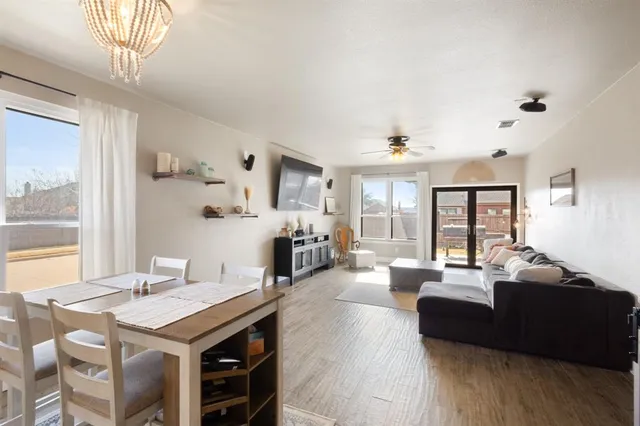 a living room with fireplace furniture and a large window