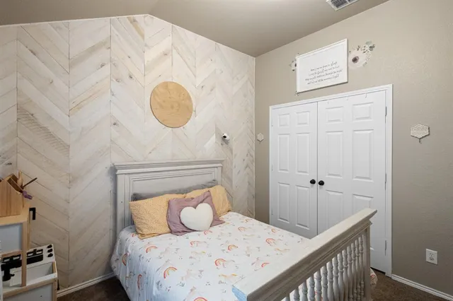 a bedroom with bed and wooden floor