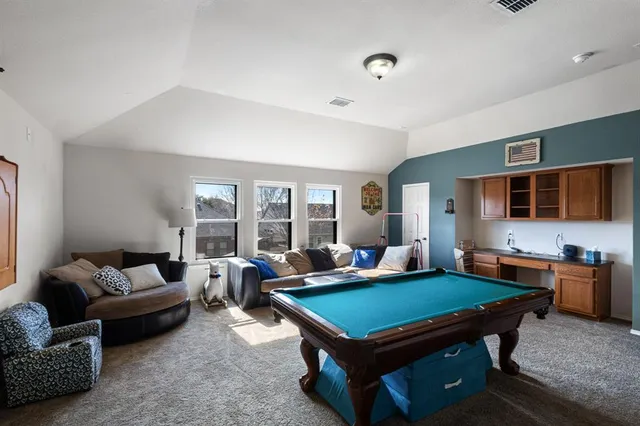 a room with furniture pool table and flat screen tv