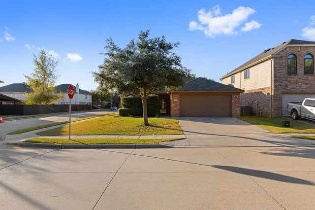 a view of a house with a backyard and a yard