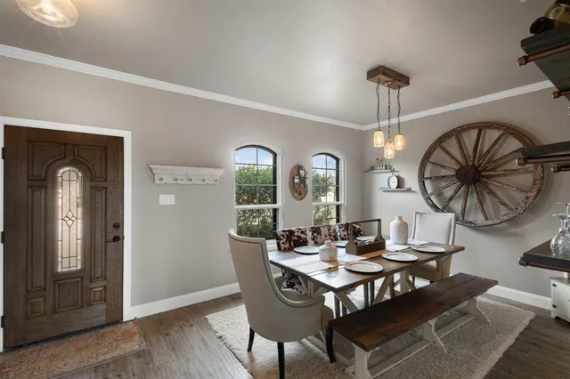 a view of a dining room with furniture and chandelier