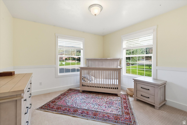 353 Robin Street Smithfield, UT 84335 - Photo 28 of 70 Bedroom with a crib, light colored carpet, and multiple windows