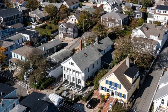 an aerial view of multiple houses with yard