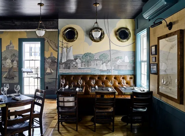 a view of a chairs and table in a balcony