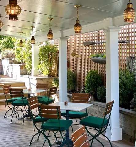 a view of a patio with a table and chairs