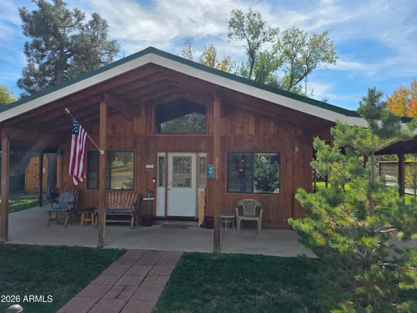 a view of a house with backyard and sitting area