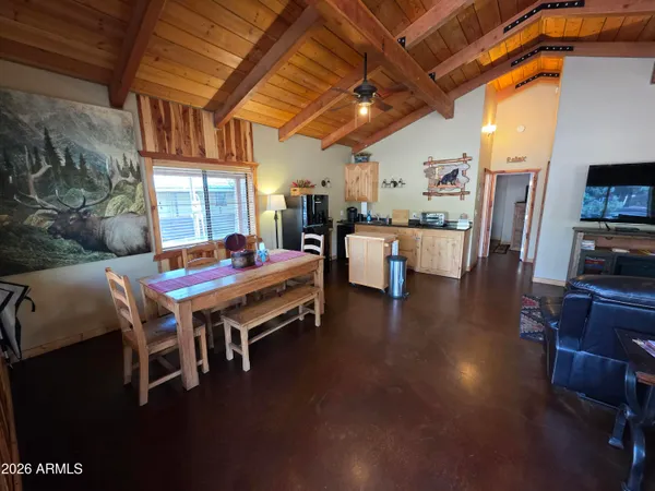 a dining room with furniture and wooden floor