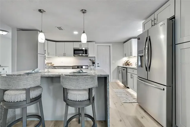 a kitchen with sink and cabinets