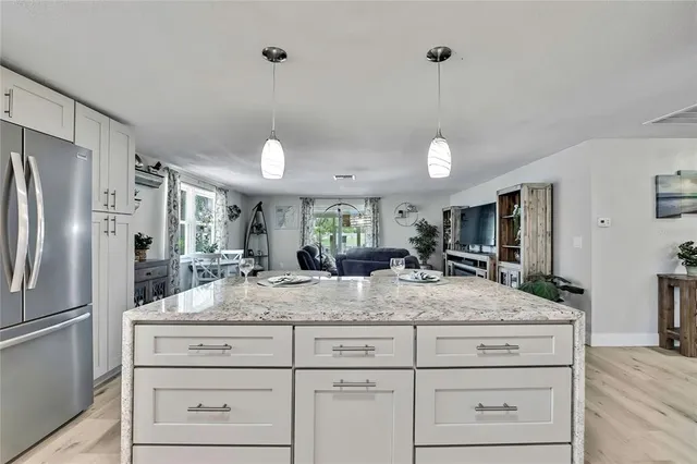 a living room with furniture a flat screen tv and a window