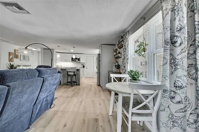 a bedroom with a bed and a flat tv screen on the wall