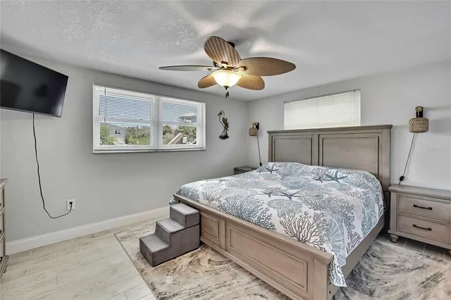 a bedroom with a bed and a chandelier