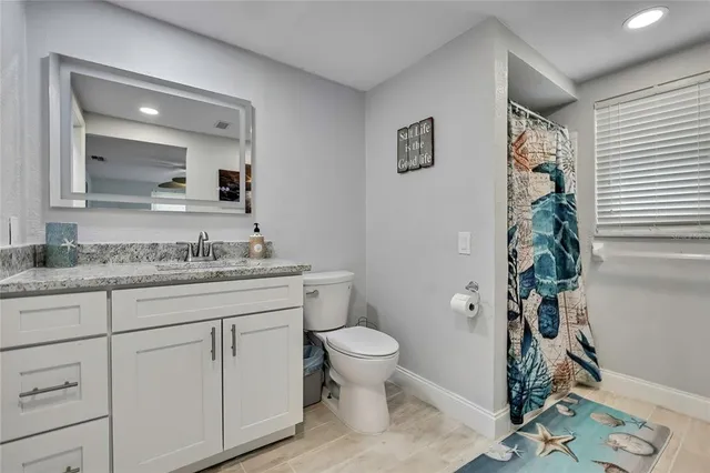 a bathroom with a toilet a sink and a mirror