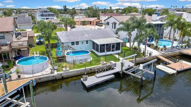 an aerial view of a house with swimming pool patio and outdoor seating