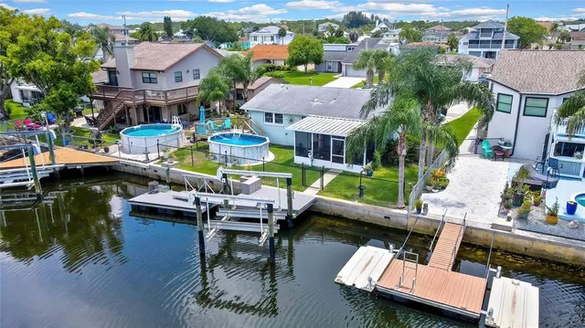 an aerial view of multiple houses with a yard