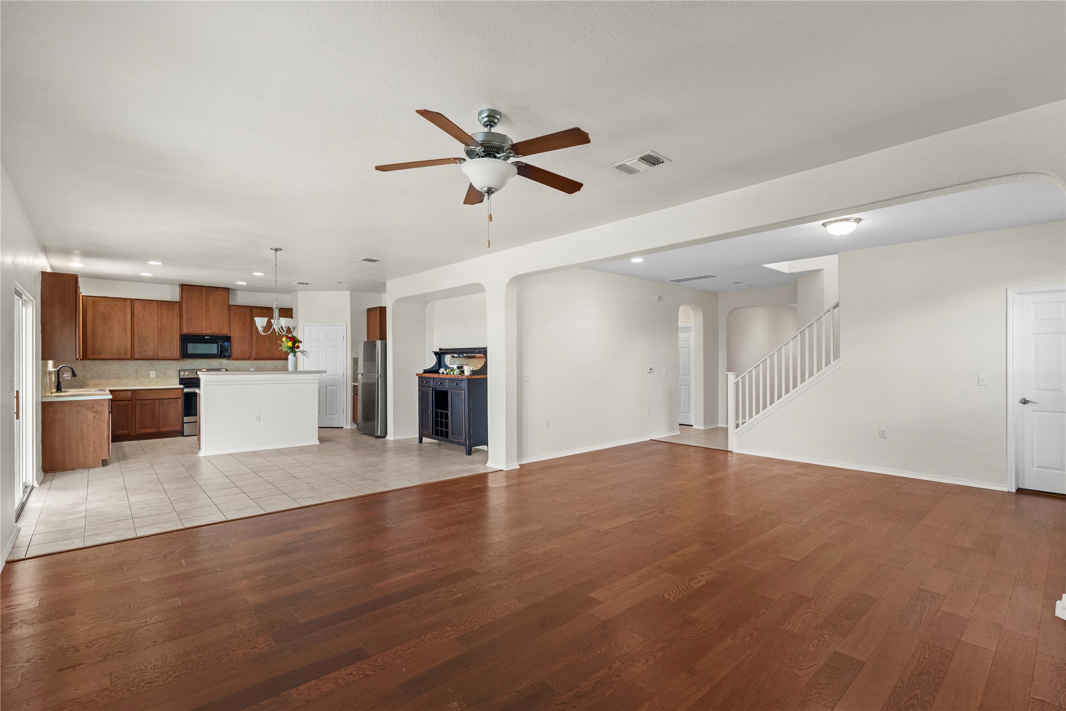 8613 Capitol View Drive Austin, TX 78747 - Photo 17 of 33 An open-concept living area flows into a kitchen with warm cabinetry and durable tile flooring.