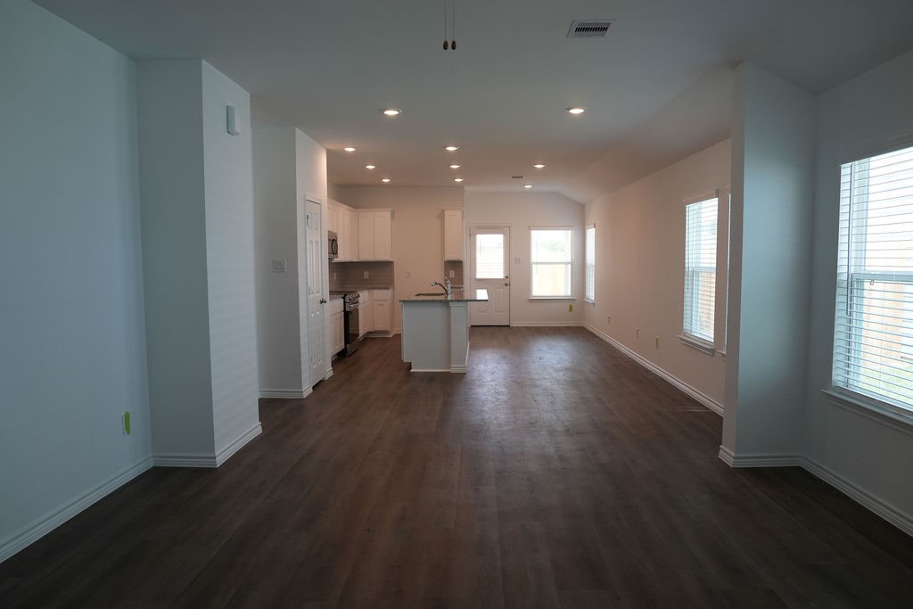 10465 Sugar Mill Drive Conroe, TX 77306 - Photo 2 of 29 an empty room with wooden floor and windows