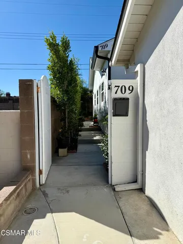 a kitchen with white cabinets and appliances