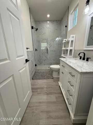 a bedroom with a bed and a potted plant