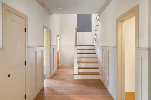 a view of entryway with wooden floor and white door