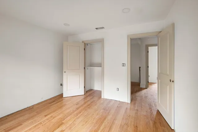 a view of a room with wooden floor