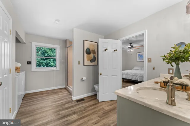 a view of a hallway with wooden floor and closet