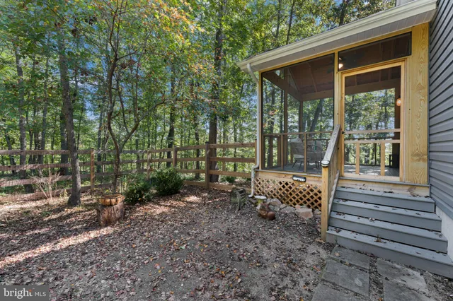 a backyard of a house with yard and outdoor seating