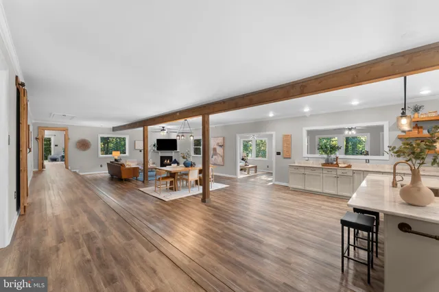 a kitchen with a table chairs refrigerator and microwave