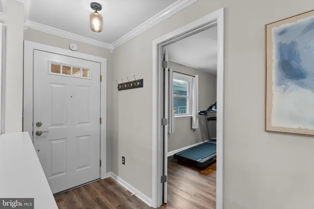 a kitchen with a table chairs sink and cabinets