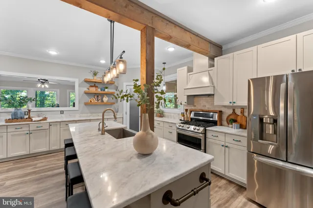 a stove top oven sitting inside of a kitchen