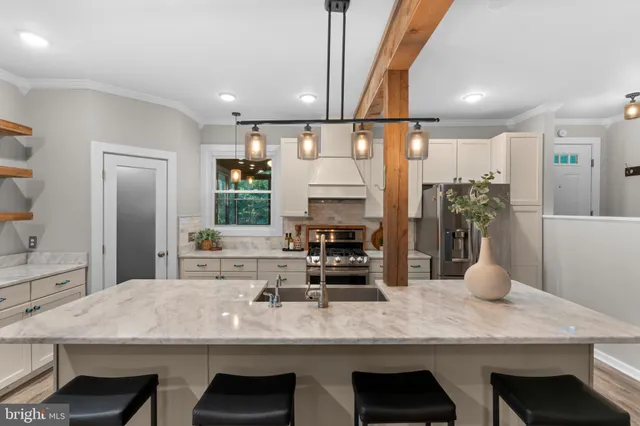 a kitchen with sink refrigerator and cabinets
