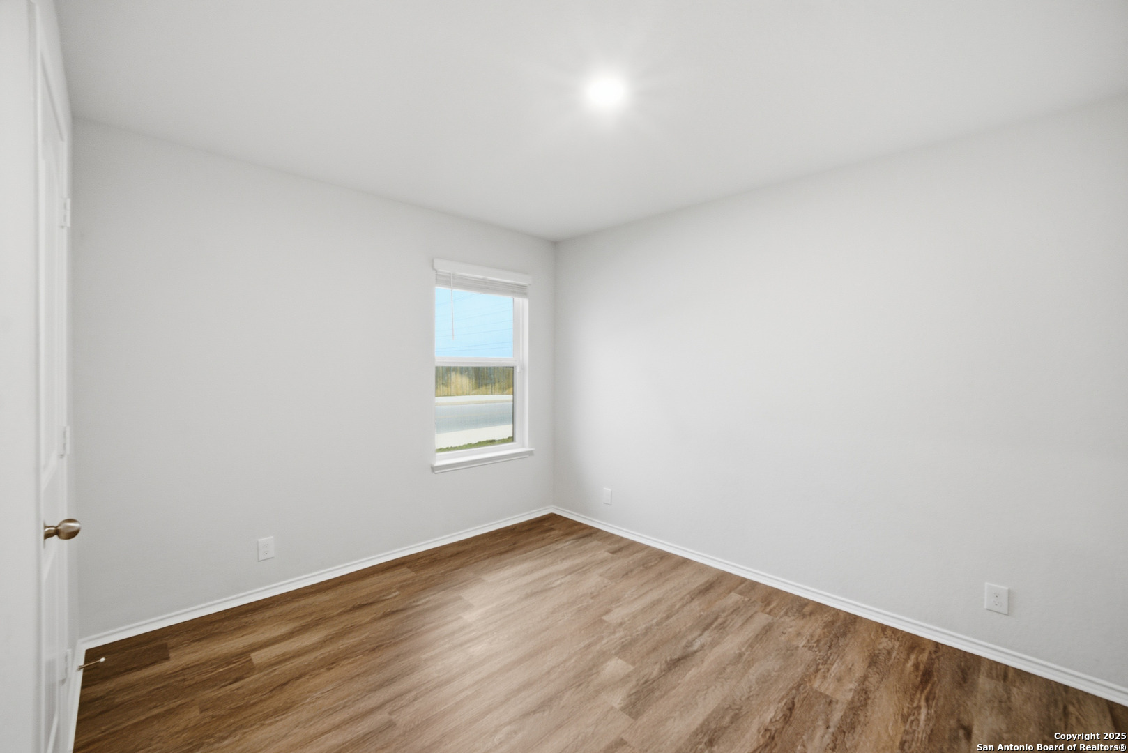 5803 Still River Converse, TX 78109 - Photo 17 of 24 a view of empty room with wooden floor and fan
