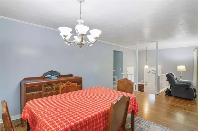 a bedroom with a bed and chandelier