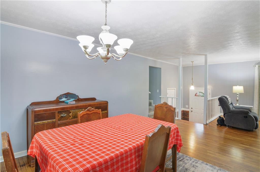 3243 Highway 184 Toccoa, GA 30577 - Photo 18 of 33 a bedroom with a bed and chandelier