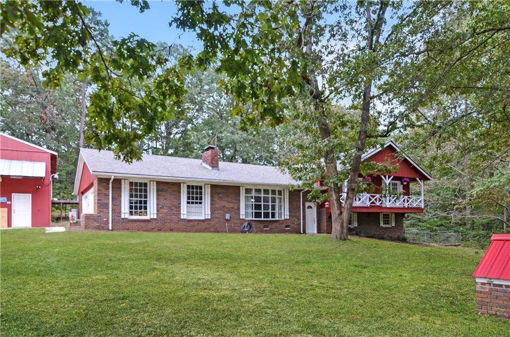3243 Highway 184 Toccoa, GA 30577 - Photo 2 of 33 a front view of a house with a garden