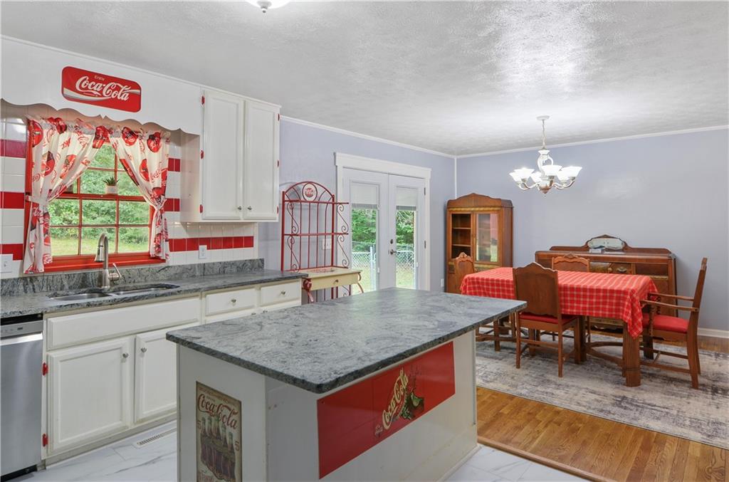 3243 Highway 184 Toccoa, GA 30577 - Photo 22 of 33 a kitchen with kitchen island granite countertop a stove a sink dishwasher and cabinets with wooden floor
