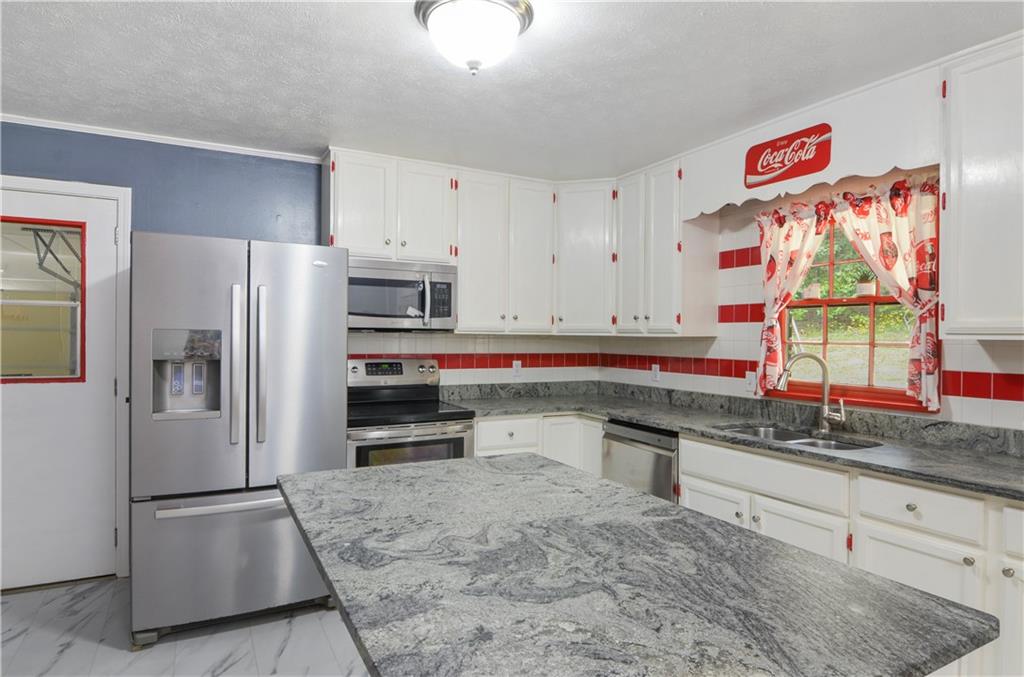 3243 Highway 184 Toccoa, GA 30577 - Photo 23 of 33 a kitchen with stainless steel appliances granite countertop a refrigerator and a sink