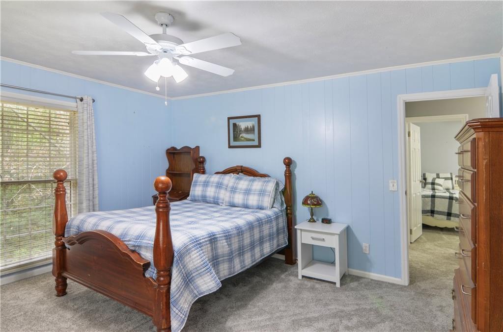 3243 Highway 184 Toccoa, GA 30577 - Photo 31 of 33 a bedroom with a bed and a chandelier