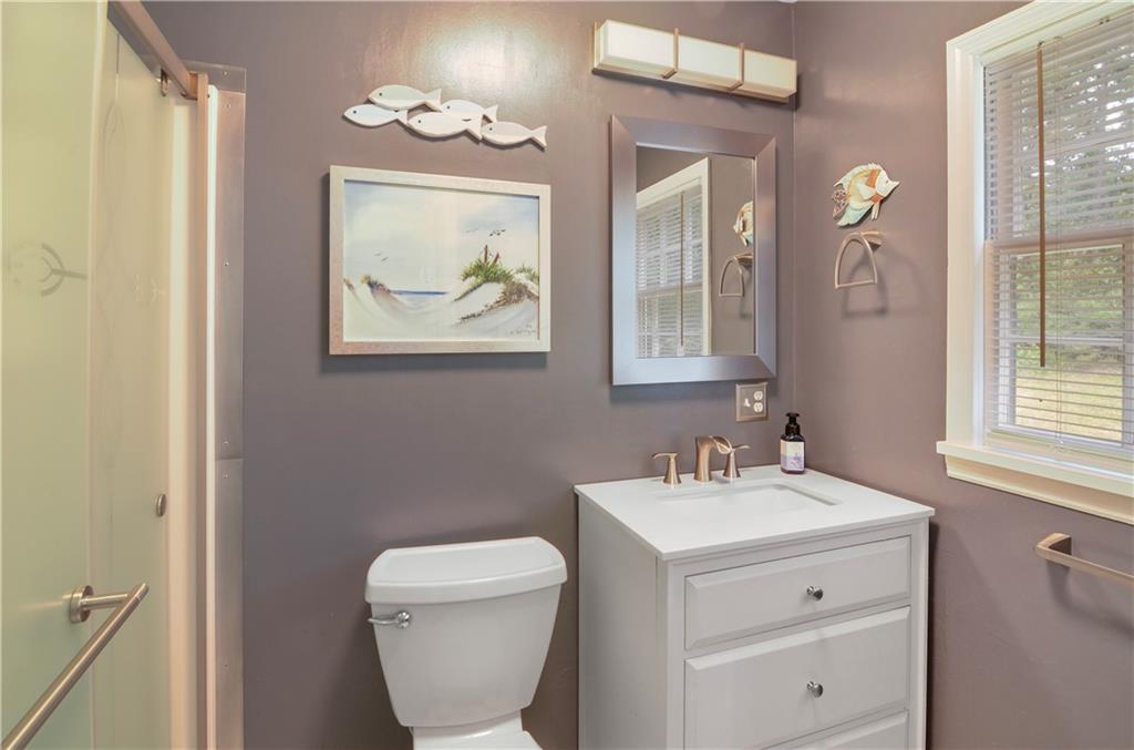 3243 Highway 184 Toccoa, GA 30577 - Photo 32 of 33 a bathroom with a toilet a sink and mirror