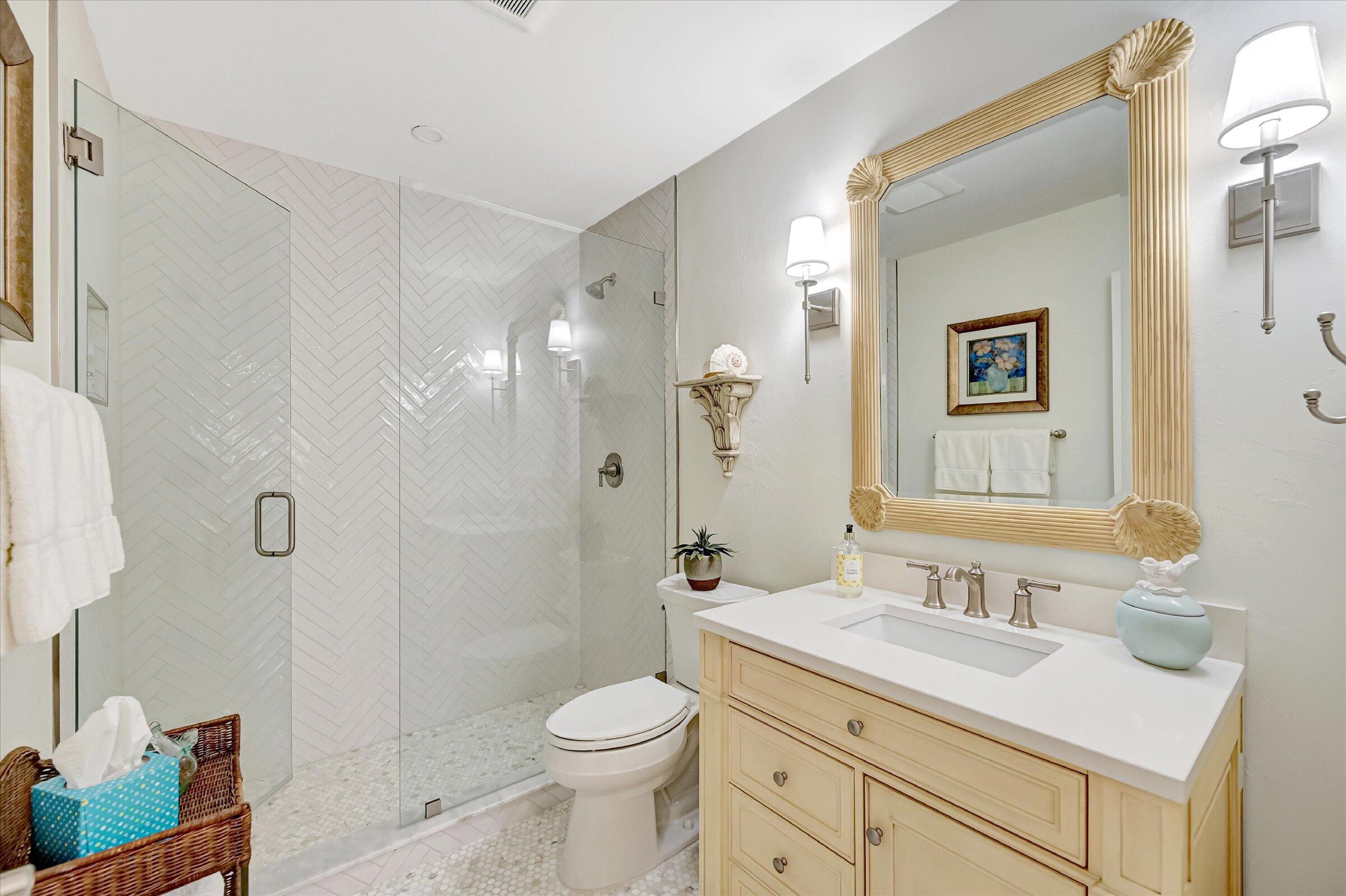 535 Augusta Boulevard, Unit 4 Naples, FL 34113 - Photo 41 of 44 a bathroom with a sink toilet vanity and shower