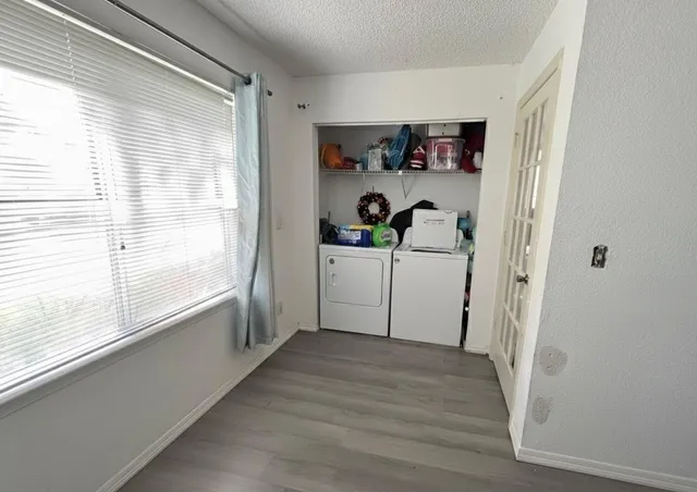a view of a kitchen with a window and refrigerator