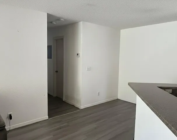 an empty room with wooden floor and closet