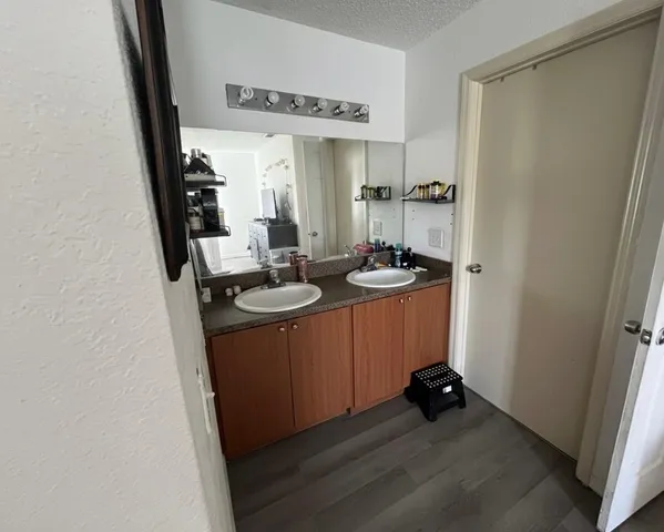a room with sink mirror and toilet