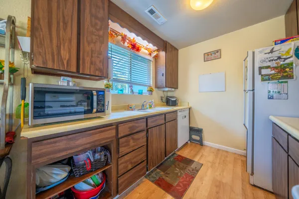 a kitchen with stainless steel appliances granite countertop a sink and cabinets